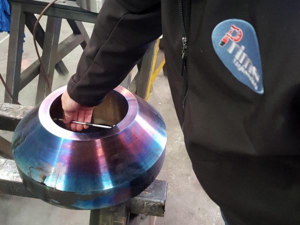 heated metal flange being checked