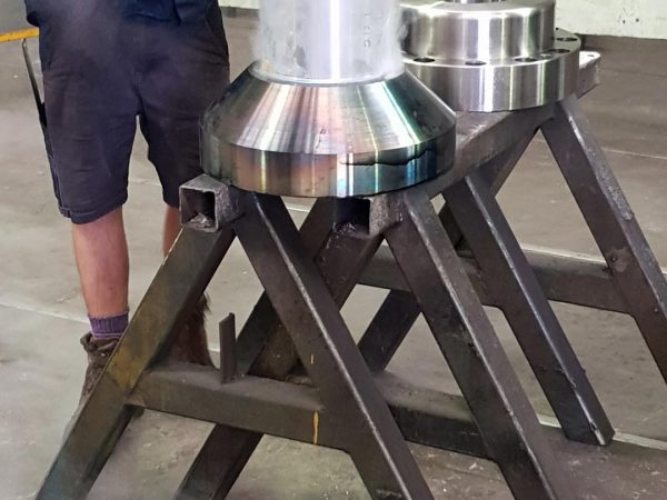 heated metal flange being pressed onto cold shaft